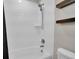 Bright and clean shower and tub with a white tile surround at 16048 Elizabeth St, Thornton, CO 80602