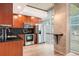 Updated kitchen featuring wood cabinets, stainless appliances, black countertops and a granite breakfast bar at 1700 Bassett St # 802, Denver, CO 80202