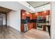 A kitchen with dark wood cabinets, stainless steel appliances, and black tile backsplash at 1700 Bassett St # 802, Denver, CO 80202