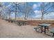 Park picnic area featuring green picnic tables and a stone wall, offering a peaceful outdoor setting at 1700 Bassett St # 802, Denver, CO 80202