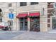 Exterior shot of Wine Dispensary store front with red awnings and street parking at 1700 Bassett St # 802, Denver, CO 80202