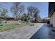 Expansive backyard featuring a patio, lush grass, and play equipment at 1641 Orchard Dr, Denver, CO 80221