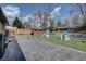 Large backyard with a patio and a variety of outdoor play equipment at 1641 Orchard Dr, Denver, CO 80221