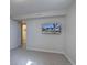 A carpeted basement with a TV and doorway leading to a bathroom with tile floor at 1641 Orchard Dr, Denver, CO 80221