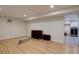 Spacious finished basement with sleek flooring, recessed lighting, and washer/dryer hookups in the next room at 1641 Orchard Dr, Denver, CO 80221