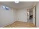 Bright basement features wood flooring, white walls and trim, and an open doorway at 1641 Orchard Dr, Denver, CO 80221
