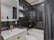 Modern bathroom features black marble tile walls, floating shelves, and new vanity at 1641 Orchard Dr, Denver, CO 80221