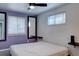 Comfortable bedroom featuring neutral walls, natural light from two windows and modern ceiling fan at 1641 Orchard Dr, Denver, CO 80221