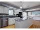 Modern kitchen featuring white cabinetry, stainless steel appliances, and a granite countertop island at 1641 Orchard Dr, Denver, CO 80221