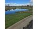 Exterior shot of a serene pond reflecting the sky, surrounded by lush greenery at 1641 Orchard Dr, Denver, CO 80221