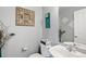 Chic half bathroom with modern fixtures, a decorative mirror, and artistic wall decor at 14300 Waterside Ln # J4, Broomfield, CO 80023