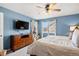 Bright bedroom boasts a large window, natural light, dresser and an exercise bike at 14300 Waterside Ln # J4, Broomfield, CO 80023