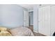 Bedroom with light blue walls and closet door slightly opened at 14300 Waterside Ln # J4, Broomfield, CO 80023