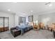 Cozy bedroom with bed, stylish seating and window providing natural light at 14300 Waterside Ln # J4, Broomfield, CO 80023