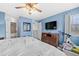 Large bedroom with TV, dresser and access to the bathroom and walk-in closet at 14300 Waterside Ln # J4, Broomfield, CO 80023