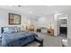Spacious bedroom with neutral colors, recessed lighting, and an en suite bathroom at 14300 Waterside Ln # J4, Broomfield, CO 80023