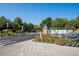 Community signage amidst lush greenery at 14300 Waterside Ln # J4, Broomfield, CO 80023