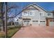 Attached two-car garage with a red driveway and grey exterior at 14300 Waterside Ln # J4, Broomfield, CO 80023