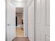 Hallway leading to a bathroom showing a shower/tub combo and adjacent closets at 14300 Waterside Ln # J4, Broomfield, CO 80023