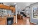 Open-concept view of kitchen flowing into living room at 14300 Waterside Ln # J4, Broomfield, CO 80023