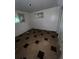 Small bedroom with linoleum flooring and basic decor; natural light limited by the two uncovered windows at 888 Wolff St, Denver, CO 80204