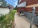 Side view of brick home, featuring house number and chain link fence at 888 Wolff St, Denver, CO 80204