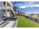 Well-maintained backyard with green lawn and stone-encased fire pit, ideal for outdoor gatherings and relaxation at 7517 Copper Sky Ct, Castle Pines, CO 80108