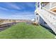 Lush backyard with green lawn, chairs and landscape, perfect for outdoor relaxation and enjoyment at 7517 Copper Sky Ct, Castle Pines, CO 80108