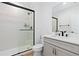 Stylish bathroom featuring a glass-enclosed shower with black hardware, a white vanity and mosaic tile accent at 7517 Copper Sky Ct, Castle Pines, CO 80108