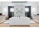 Modern bathroom with a freestanding tub, black fixtures, and decorative black-and-white accent tiles in showers at 7517 Copper Sky Ct, Castle Pines, CO 80108