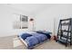 Bright bedroom with a blue comforter, white headboard, decorative ladder and window bringing in lots of light at 7517 Copper Sky Ct, Castle Pines, CO 80108