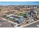 Aerial view of a community pool, amenity center, and surrounding green spaces in a planned neighborhood at 7517 Copper Sky Ct, Castle Pines, CO 80108