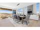 Bright dining area showcasing modern chandelier, large windows, and walk-out balcony at 7517 Copper Sky Ct, Castle Pines, CO 80108