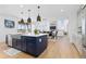 Open-concept kitchen with an island, modern appliances, and seamless flow to the living and dining areas at 7517 Copper Sky Ct, Castle Pines, CO 80108