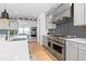 Gourmet kitchen featuring stainless steel appliances, custom cabinetry, and a marble countertop island at 7517 Copper Sky Ct, Castle Pines, CO 80108