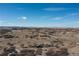 Expansive landscape view showcasing a vast open field with scattered vegetation and distant mountain range backdrop at 7517 Copper Sky Ct, Castle Pines, CO 80108