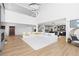 Expansive living room with a large sectional, modern lighting, and an open layout to the kitchen at 7517 Copper Sky Ct, Castle Pines, CO 80108