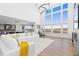 Bright living room with soaring ceilings, large windows, modern lighting and a decorative fireplace at 7517 Copper Sky Ct, Castle Pines, CO 80108