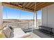 Relaxing porch featuring a swing bed, perfect for enjoying the scenic views at 7517 Copper Sky Ct, Castle Pines, CO 80108