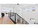 Modern staircase with black railings, bright walls and contemporary lighting at 7517 Copper Sky Ct, Castle Pines, CO 80108