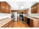 A kitchen featuring wood cabinets and stainless steel refrigerator at 11945 W 66Th Pl # A, Arvada, CO 80004