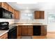 Charming kitchen featuring wood cabinets and black appliances at 11945 W 66Th Pl # A, Arvada, CO 80004