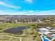 Beautiful aerial view of community with swimming pool and surrounding neighborhood against a backdrop of mountains and blue sky at 2872 Dreamcatcher Loop, Castle Rock, CO 80109