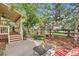 Backyard with a covered porch, patio area, and garden space with fresh landscaping, providing outdoor living at 2872 Dreamcatcher Loop, Castle Rock, CO 80109