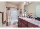 Full bathroom featuring a vanity with granite countertop, full tub, and shower combination at 2872 Dreamcatcher Loop, Castle Rock, CO 80109