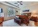 Beautiful bedroom featuring a tray ceiling, large window, and hardwood furniture at 2872 Dreamcatcher Loop, Castle Rock, CO 80109