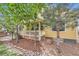 Exterior view of a house with a covered porch, decorative stone landscaping, and manicured trees, a welcoming scene at 2872 Dreamcatcher Loop, Castle Rock, CO 80109