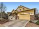 Inviting two-story home featuring a covered front porch, stone accents, and a two-car garage at 2872 Dreamcatcher Loop, Castle Rock, CO 80109