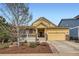 Charming yellow single-Gathering home boasts a welcoming front porch and a two-car attached garage at 2872 Dreamcatcher Loop, Castle Rock, CO 80109