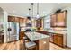 Modern kitchen with a center island, stainless steel appliances, and wooden cabinets at 2872 Dreamcatcher Loop, Castle Rock, CO 80109